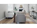 Bright living room featuring modern decor, fresh paint, fireplace, and lots of seating at 717 S A St, Elwood, IN 46036