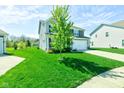 A lovely two-story home with a green lawn and tree in the front yard, offering curb appeal at 745 S Summerhaven Ct, New Palestine, IN 46163