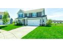 Beautiful two-story home with a two-car garage and a well-kept lawn on a sunny day at 745 S Summerhaven Ct, New Palestine, IN 46163