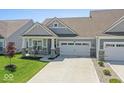 Charming single-story home featuring a two-car garage, covered porch, and well-maintained lawn at 75 Hovden Dr, Cicero, IN 46034