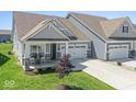 Attractive single-story home with a two-car garage, covered porch, and lush green lawn at 75 Hovden Dr, Cicero, IN 46034