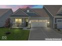 Charming single-story home featuring a two-car garage, covered porch, and well-maintained lawn at twilight at 75 Hovden Dr, Cicero, IN 46034