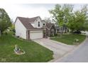 Well-maintained two-story home with lush lawn, a two-car garage, and a long driveway at 8875 White Fir Dr, Indianapolis, IN 46256