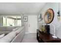 Bright living room showcasing a comfortable sofa, decorative accents, and a view to an outdoor covered patio at 9748 W Sunset Ln, Elwood, IN 46036