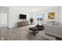 Bright living room featuring hardwood floors, neutral decor and sliding glass doors with water view at 10250 Camp Creek Way, Indianapolis, IN 46229