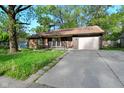 View of a single-story home featuring a driveway and attached garage at 112 Coronado Rd, Indianapolis, IN 46234