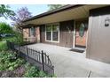 Inviting front porch of a single-story home with wood door at 112 Coronado Rd, Indianapolis, IN 46234