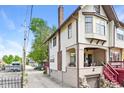 A townhouse exterior showing the entry and garage on a sunny day at 114 E 27Th St, Indianapolis, IN 46205