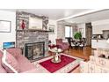 Inviting living room with a brick fireplace, plush seating, and hardwood floors at 114 E 27Th St, Indianapolis, IN 46205