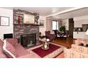 Cozy living room with a brick fireplace, plush seating, and warm lighting at 114 E 27Th St, Indianapolis, IN 46205