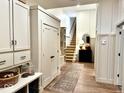 Inviting entryway with storage, staircase, and stylish decor and wood flooring at 114 S Walnut St, Muncie, IN 47305