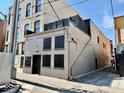 Exterior back view of a multi-story building with a private rooftop patio at 114 S Walnut St, Muncie, IN 47305