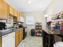 Functional kitchen featuring wood cabinets, black appliances, and a cozy dining area at 1408 W Jackson St, Muncie, IN 47303