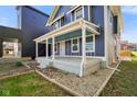 Charming two-story home with a spacious front porch, perfect for relaxing and enjoying the outdoors at 1417 E Michigan St, Indianapolis, IN 46201