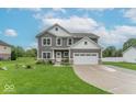 Inviting two-story home with gray siding, white trim, a two-car garage, and a lush front lawn at 1417 Layton Rd, Anderson, IN 46011