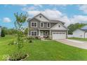 Beautiful two-story home featuring gray siding, a well-maintained lawn, and tasteful landscaping at 1417 Layton Rd, Anderson, IN 46011