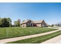 Beautifully landscaped brick home with a two-car garage in a quiet neighborhood at 1426 Manchester Dr, Danville, IN 46122