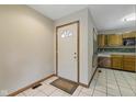 Inviting foyer with tiled flooring, white front door, and view into the kitchen at 15 Northridge Ct, Brownsburg, IN 46112