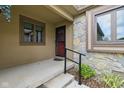 Charming front entry with stone accents, tidy landscaping, and a black handrail at 15 Northridge Ct, Brownsburg, IN 46112