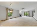 Bright living room with a fireplace, neutral carpet, and sliding doors to the patio at 15 Northridge Ct, Brownsburg, IN 46112