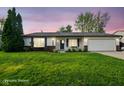 Charming single-story home featuring a well-manicured lawn, attached garage, and inviting front porch at 155 Suncrest Dr, Greenwood, IN 46143