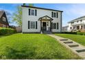 Charming two-story home featuring a well-manicured lawn and classic architectural details at 17 W Washington St, Mooresville, IN 46158