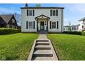 Charming two-story home featuring a well-manicured lawn and classic architectural details at 17 W Washington St, Mooresville, IN 46158