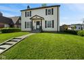 Charming two-story home featuring a well-manicured lawn and classic architectural details at 17 W Washington St, Mooresville, IN 46158