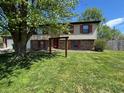 Charming two-story home with brick and vinyl siding, a well-maintained lawn, and mature trees at 1705 Witt Rd, Lebanon, IN 46052