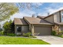 Inviting townhouse featuring stone accents, a two-car garage, and a neatly kept lawn at 2236 Calaveras Way, Indianapolis, IN 46240