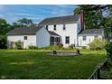 Spacious backyard featuring a screened-in porch, lush greenery, and mature trees at 2405 Sycamore St, Columbus, IN 47201