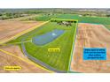 Aerial view of a 13.31-acre property with a pond and fountain, including the adjacent 10.01-acre lot next door at 2575 W 100 S, Franklin, IN 46131