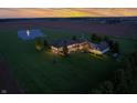 Aerial view showcasing the estate, meticulously maintained lawn, guest house, and sunset at 2575 W 100 S, Franklin, IN 46131