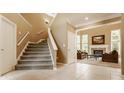 Inviting foyer with staircase leading to the living room with fireplace and large windows at 269 Manchester Ct, Noblesville, IN 46060