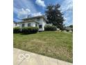 Traditional home featuring a lush green lawn and mature landscaping at 302 E Main St, Greenfield, IN 46140