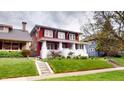 Classic two-story house with a red exterior, white trim, and a well-manicured front lawn at 319 N Ridgeview Dr, Indianapolis, IN 46219
