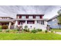 Charming two-story home with lush landscaping, brick foundation, and covered front porch at 319 N Ridgeview Dr, Indianapolis, IN 46219