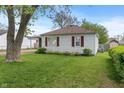 Attractive one-story home with tidy lawn and side garage access, and an old shade tree at 327 S Biltmore Ave, Indianapolis, IN 46241