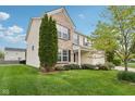 Side view of a two-story home with a green lawn and manicured landscaping at 3430 Burlingame Blvd, Westfield, IN 46074