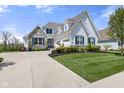 Stunning home with stone accents, blue shutters, and well-maintained landscaping at 3678 Sugar Pine Ln, Zionsville, IN 46077