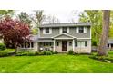 Beautiful two-story home with stone accents, lush lawn, and mature landscaping at 440 E 82Nd St, Indianapolis, IN 46240