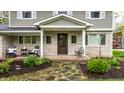Cozy front porch with seating, stone details, and manicured landscaping at 440 E 82Nd St, Indianapolis, IN 46240
