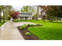 Inviting home with a long driveway and meticulously landscaped front yard at 440 E 82Nd St, Indianapolis, IN 46240