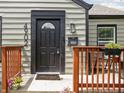 Inviting front entry with stylish door, updated hardware, and a charming welcome mat at 4902 Kingsley Dr, Indianapolis, IN 46205