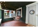 Inviting front porch with a swing, wreath and ambient lighting at 4917 N Park Ave, Indianapolis, IN 46205