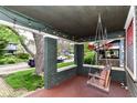 Relaxing front porch featuring hanging swing and ambient string lights at 4917 N Park Ave, Indianapolis, IN 46205
