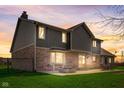 A spacious backyard featuring a stone fire pit and patio furniture, perfect for outdoor entertaining at 4940 Sundance Trl, Indianapolis, IN 46239