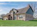 A beautiful home with a brick and siding exterior and a well-maintained lawn on a sunny day at 4940 Sundance Trl, Indianapolis, IN 46239