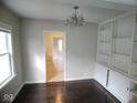 Inviting dining room with built-in shelving and classic chandelier lighting at 5080 Norwaldo Ave, Indianapolis, IN 46205