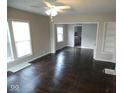 Open-concept living area featuring hardwood floors, neutral walls, and ceiling fan at 5080 Norwaldo Ave, Indianapolis, IN 46205